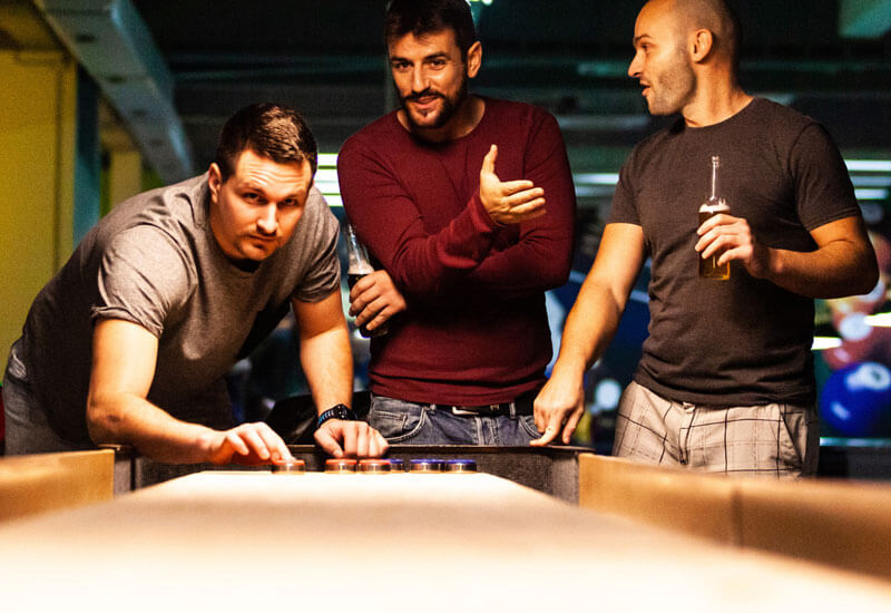 Men at bar playing game